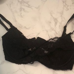 Black lace crosses over breast bra